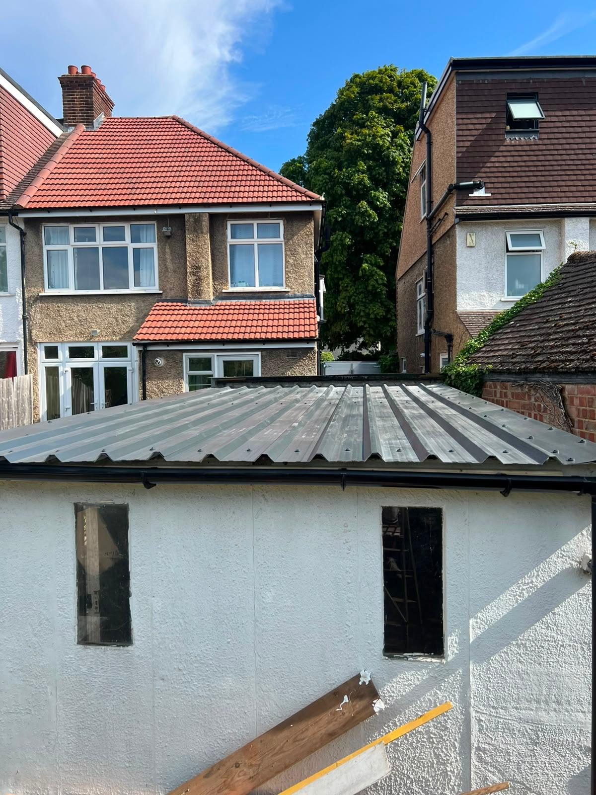 Finished garage roof replacement — corrugated metal sheets, new guttering — Croydon