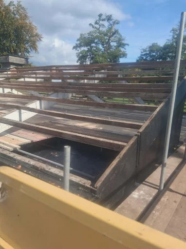 Asbestos cement sheets stripped back to the timber frame during garage demolition
